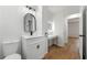 Modern bathroom with a vanity, sink, and mirror, complemented by wood-look flooring and neutral walls at 1917 Connally Dr, Atlanta, GA 30344