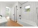 Bathroom featuring a white subway-tiled shower/tub and modern fixtures under a bright window at 1917 Connally Dr, Atlanta, GA 30344