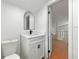 Compact bathroom with modern fixtures, vanity, mirror, and a view to the stairway landing at 1917 Connally Dr, Atlanta, GA 30344