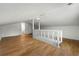 Bright bonus room featuring light-colored wood flooring and a white banister, open floorplan at 1917 Connally Dr, Atlanta, GA 30344