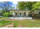 Classic home exterior with a welcoming porch framed by black railings and freshly cut green lawn at 1917 Connally Dr, Atlanta, GA 30344