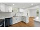 Well-lit kitchen featuring white cabinets, modern appliances, and hardwood floors at 1917 Connally Dr, Atlanta, GA 30344