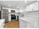 Modern kitchen with white cabinets, stainless steel appliances, and subway tile backsplash at 1917 Connally Dr, Atlanta, GA 30344