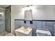 Bathroom featuring a modern shower, tiled wall, sink and toilet at 3137 Ardley Sw Rd, Atlanta, GA 30311