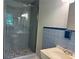 Bathroom with a tiled shower, vessel sink, and blue tiled accents at 3137 Ardley Sw Rd, Atlanta, GA 30311