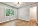 Cozy bedroom with hardwood floors, a decorative light fixture, and a view of the outdoors at 3137 Ardley Sw Rd, Atlanta, GA 30311