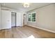Bedroom featuring hardwood floors, closet, and a window at 3137 Ardley Sw Rd, Atlanta, GA 30311