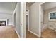 Hallway with hardwood floors leading to a bathroom and another room with a fireplace at 3137 Ardley Sw Rd, Atlanta, GA 30311