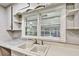 Close-up of the kitchen sink with white cabinets and a bright window view, highlighting functionality at 3137 Ardley Sw Rd, Atlanta, GA 30311