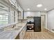Functional kitchen with laminate floors, ample counter space, and a classic oven at 3137 Ardley Sw Rd, Atlanta, GA 30311
