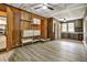Open-concept living room with laminate flooring, built-in shelves, and access to additional rooms at 3137 Ardley Sw Rd, Atlanta, GA 30311