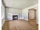 Bright living room featuring hardwood floors, a classic fireplace, and ample natural light at 3137 Ardley Sw Rd, Atlanta, GA 30311