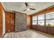 Inviting sunroom with wood paneling, a brick accent, laminate floors, and many windows at 3137 Ardley Sw Rd, Atlanta, GA 30311