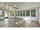 Sun-filled sunroom with laminate flooring, a wall of windows, and a ceiling fan for year-round enjoyment at 3137 Ardley Sw Rd, Atlanta, GA 30311
