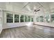 Bright sunroom featuring lots of windows, wood floors, and a ceiling fan at 3137 Ardley Sw Rd, Atlanta, GA 30311