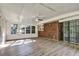 Bright sunroom featuring brick accent wall, many windows, and a ceiling fan at 3137 Ardley Sw Rd, Atlanta, GA 30311