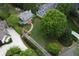 Aerial view of a home and surrounding manicured lawn, mature trees, and gardens at 4220 Club Ne Dr, Atlanta, GA 30319