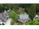 Stunning aerial view of an estate home with lush landscaping and mature trees at 4220 Club Ne Dr, Atlanta, GA 30319