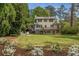 Picture of a house with a beautiful, well-kept green lawn, landscaping, deck and patio at 4220 Club Ne Dr, Atlanta, GA 30319