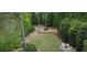 Backyard features a charming patio area with outdoor seating, lush green lawn, and surrounding mature trees at 4220 Club Ne Dr, Atlanta, GA 30319