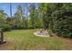 Private backyard patio with comfortable seating, lush green grass, and privacy landscaping at 4220 Club Ne Dr, Atlanta, GA 30319