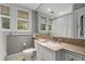 Bright bathroom featuring a large vanity, modern fixtures, and natural light from the shuttered windows at 4220 Club Ne Dr, Atlanta, GA 30319