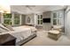 Elegant bedroom featuring large windows, a ceiling fan, and a cozy sitting area with chair at 4220 Club Ne Dr, Atlanta, GA 30319