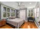 Comfortable bedroom featuring hardwood floors, a ceiling fan, and multiple bright windows at 4220 Club Ne Dr, Atlanta, GA 30319
