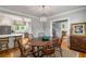Charming dining room with hardwood floors adjacent to the bright kitchen with white cabinets at 4220 Club Ne Dr, Atlanta, GA 30319