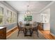 Bright dining room with beautiful wood floors, stylish light fixture, and views to an adjacent eat-in kitchen at 4220 Club Ne Dr, Atlanta, GA 30319