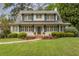 Well-maintained two-story home with shutters, landscaping, and a brick entryway with an American flag at 4220 Club Ne Dr, Atlanta, GA 30319