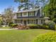 Charming two-story traditional home with shutters and a landscaped front yard on a sunny day at 4220 Club Ne Dr, Atlanta, GA 30319