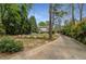 Beautiful landscaped yard, long driveway, and an expansive backyard with mature trees provide privacy at 4220 Club Ne Dr, Atlanta, GA 30319