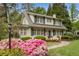 Charming two-story home with a landscaped front yard and a walkway leading to the front porch at 4220 Club Ne Dr, Atlanta, GA 30319
