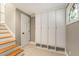 Hallway featuring hardwood stairs and floors, custom built in cabinets, and a unique stain glass window at 4220 Club Ne Dr, Atlanta, GA 30319