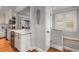 Open kitchen design with white cabinets, island with wine cooler, and hardwood floors at 4220 Club Ne Dr, Atlanta, GA 30319
