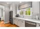 Bright kitchen offers white cabinets, marble countertops, stainless appliances, and a sunlit window at 4220 Club Ne Dr, Atlanta, GA 30319