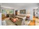 Inviting living room with hardwood floors, fireplace, neutral furnishings, and abundant natural light at 4220 Club Ne Dr, Atlanta, GA 30319