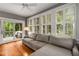 Inviting living room with hardwood floors, a large sectional couch, and natural light streaming through shuttered windows at 4220 Club Ne Dr, Atlanta, GA 30319