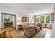 Comfortable living room boasts hardwood floors, neutral tones, and natural light from large windows at 4220 Club Ne Dr, Atlanta, GA 30319