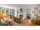 Inviting living room with hardwood floors, fireplace, neutral furnishings, and abundant natural light at 4220 Club Ne Dr, Atlanta, GA 30319