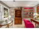 Cozy sitting room featuring vintage wooden furniture, colorful shelving, and a pink accent chair at 4220 Club Ne Dr, Atlanta, GA 30319