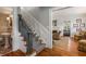 Charming staircase with decorative wainscoting, hardwood floors, and views into the adjoining living spaces at 4220 Club Ne Dr, Atlanta, GA 30319
