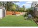 Spacious backyard featuring a shed, a fire pit and a lawn mower at 1268 Windsor Glen Dr, Douglasville, GA 30134