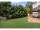 View of a lush, well-maintained backyard with a patio and mature trees offering shade and privacy at 1268 Windsor Glen Dr, Douglasville, GA 30134