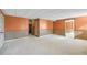 Partially finished basement with carpet, wood paneling, and access to a staircase at 1268 Windsor Glen Dr, Douglasville, GA 30134