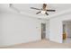 Neutral bedroom with tray ceiling, carpeted floor, and a view to the hall and bath at 1268 Windsor Glen Dr, Douglasville, GA 30134