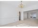 Open dining room with neutral carpet, chandelier, and natural light at 1268 Windsor Glen Dr, Douglasville, GA 30134