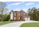 Brick home with a well-maintained front lawn, driveway, and a two-car garage at 1268 Windsor Glen Dr, Douglasville, GA 30134
