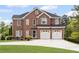 Stately two-story brick home featuring a two-car garage and manicured front lawn at 1268 Windsor Glen Dr, Douglasville, GA 30134